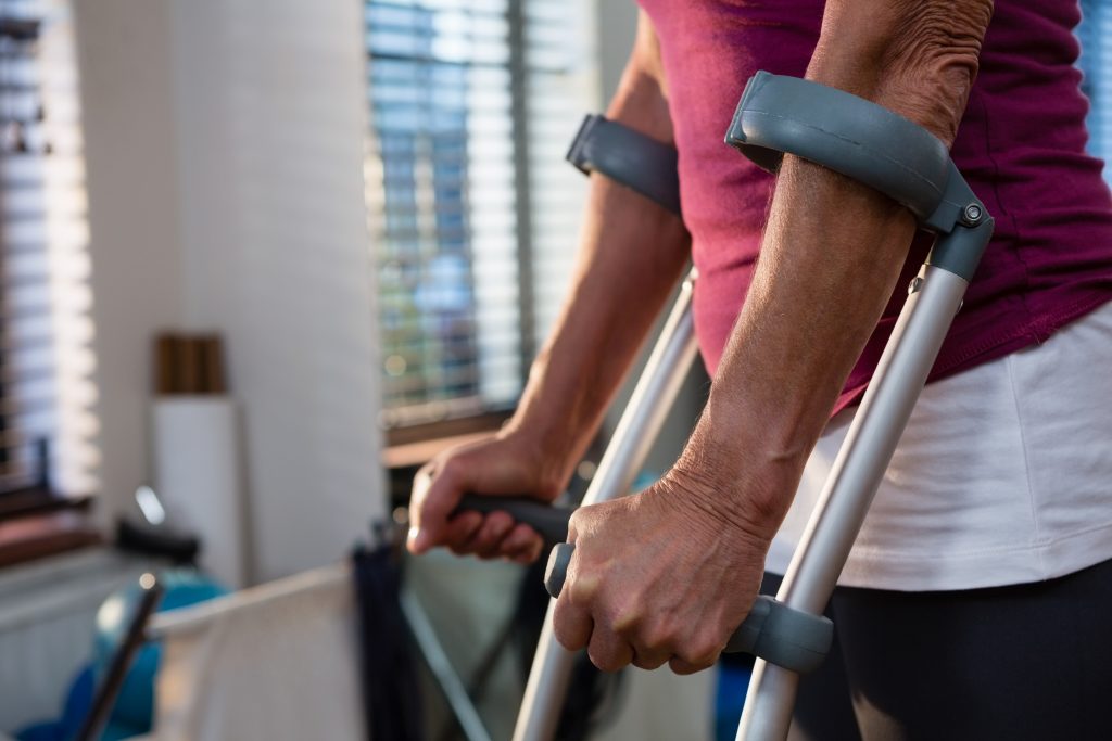 Mid-section of woman with crutches